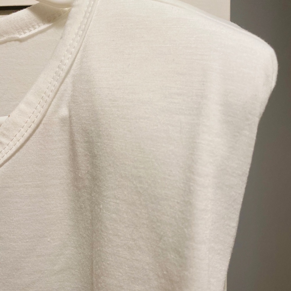 White muscle shirt with shoulder pads.